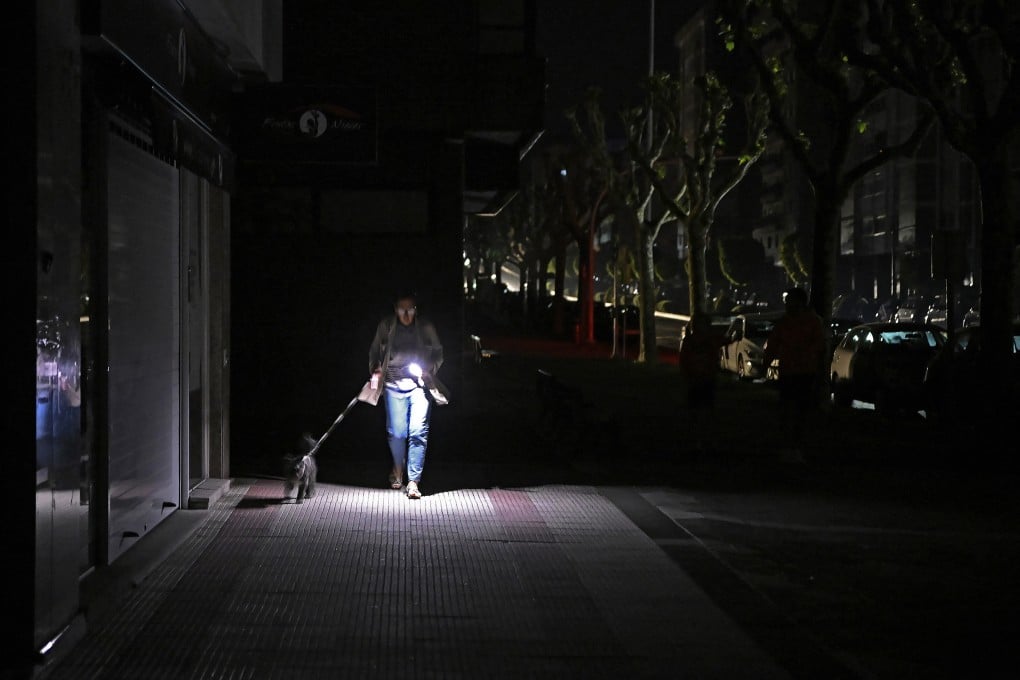 A woman walks her dog in Vigo, Spain. The country was among the European nations hit by a massive power cut on Monday. Photo: AFP/Getty Images/TNS