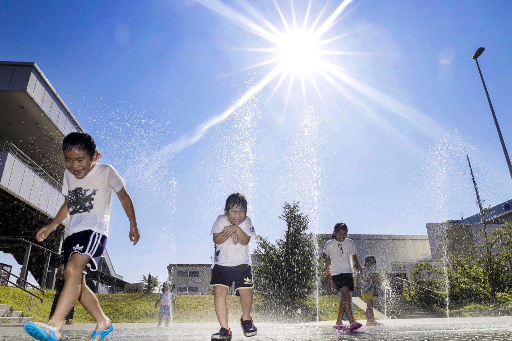 Children play with water in Tajimi, Gifu Prefecture, central Japan, amid scorching summer heat. Rising temperatures in Japan may halt outdoor children’s sports by 2060, experts say. Photo: Kyodo