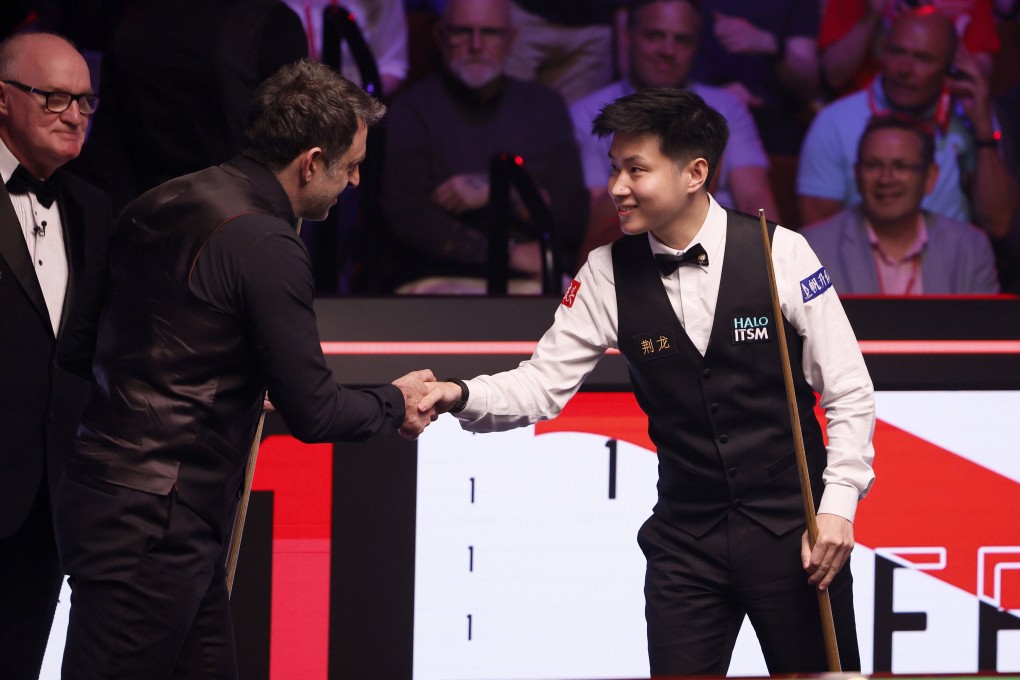 Ronnie O’Sullivan shakes hands with Zhao Xintong (right) ahead of their World Snooker Championship semi-final at the Crucible. Photo: AP