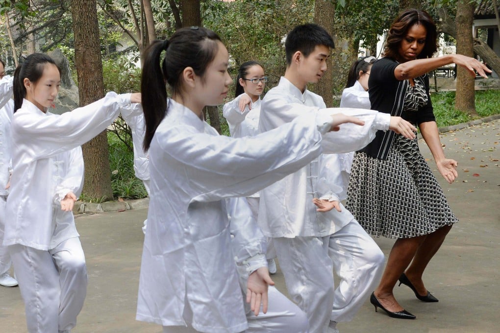 US first lady Michelle Obama tries tai chi with Chinese students in Chengdu, Sichuan province in 2014. Chinese philosophies like Confucianism, Taoism and the Yinyang school provide ways to understand China and the world differently. Photo: AFP