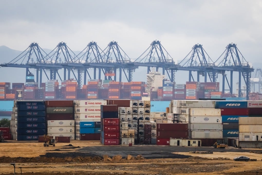 Shipping containers are stacked in front of docked vessels and gantry cranes at the Yantian International Container Terminal on April 12, 2025, in Shenzhen. Photo: Getty Images/TNS