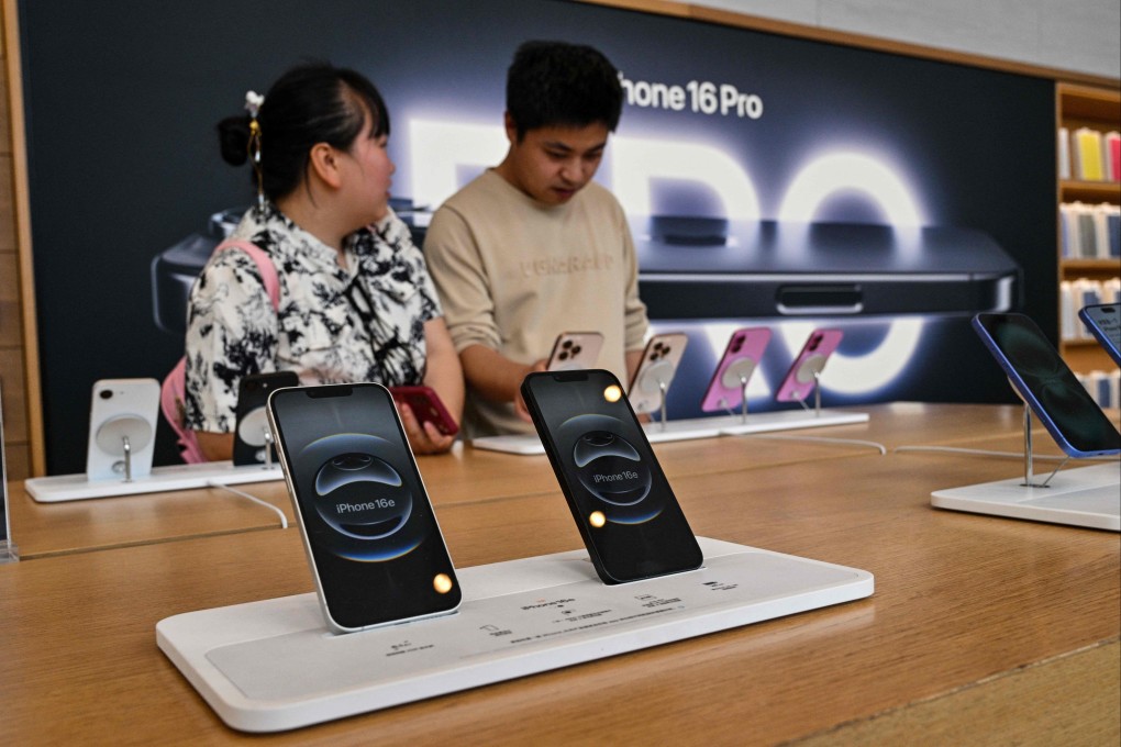 Customers look at iPhones in an Apple store in the Huangpu district in Shanghai. Photo: AFP