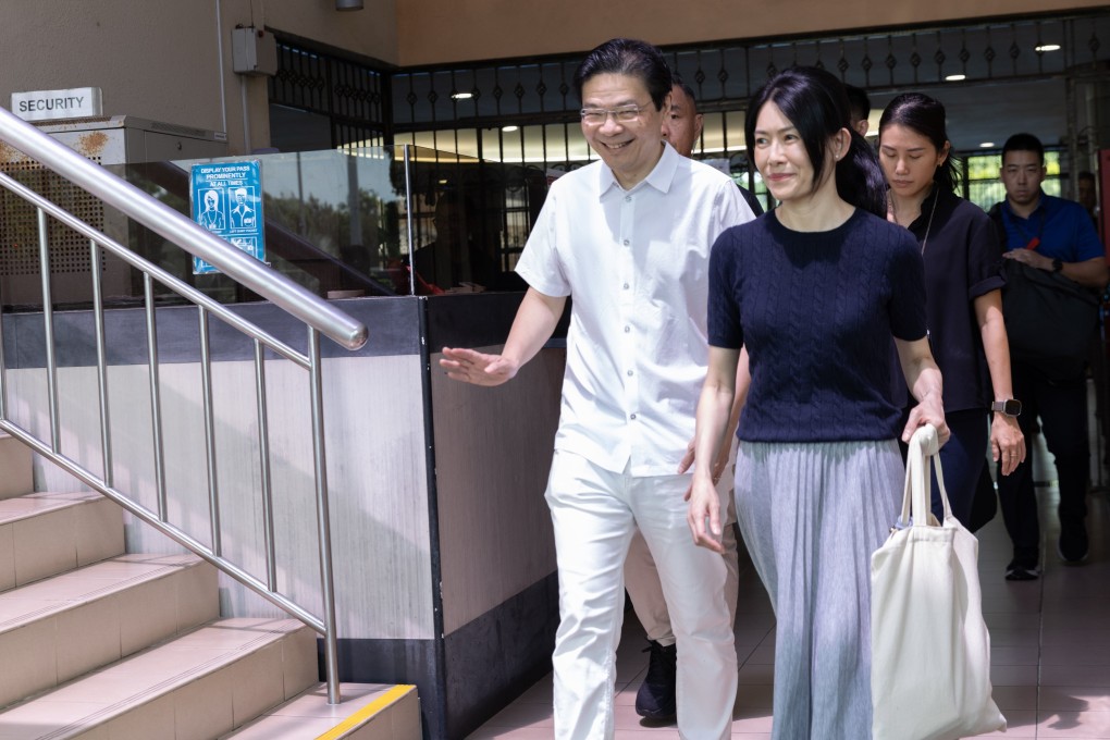 Singapore’s Prime Minister Lawrence Wong and his wife leave after voting at a polling station on Saturday. Photo: EPA-EFE
