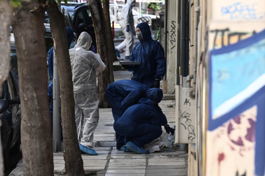 Greek police experts search for evidence after a bomb explosion in Thessaloniki on Saturday that killed a woman. Photo: AFP
