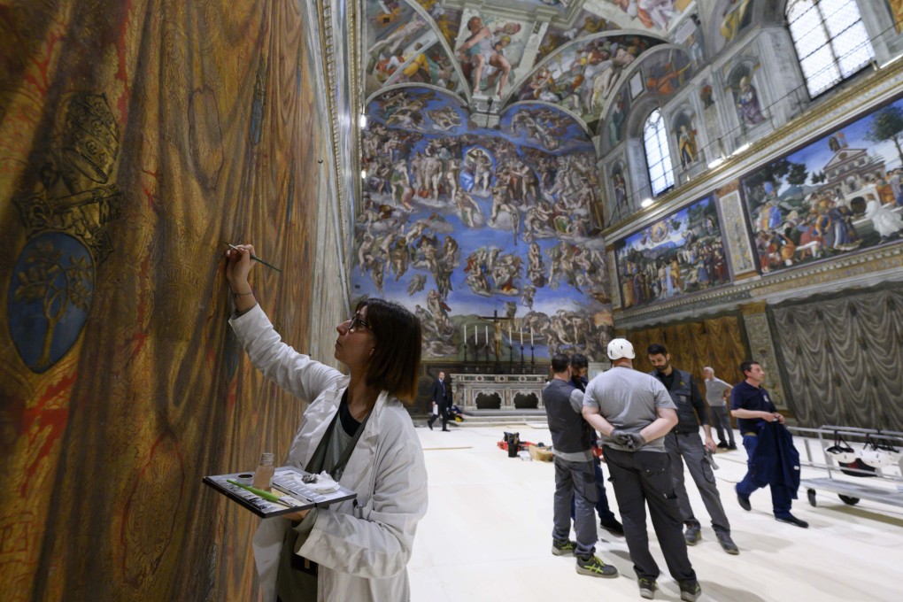 A worker restoring frescos inside the Sistine Chapel on Friday ahead of the conclave in Vatican City. Photo: Vatican Media via EPA-EFE