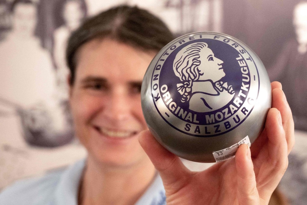 An employee at Cafe Konditorei Fuerst displays original handmade Mozartkugel chocolates at Cafe Konditorei Fuerst in Salzburg, Austria, on April 16. Photo: AFP