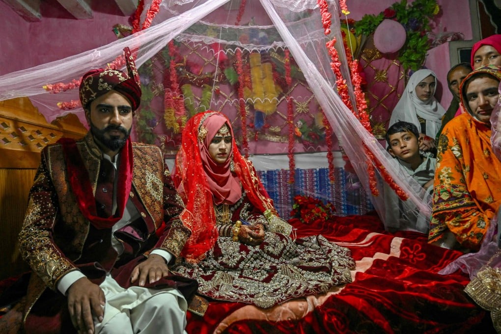 Groom Chaudhry Junaid sits with his bride, Rabia Bibi, during their wedding ceremony in Ashkot village on the Line of Control (LoC) in Neelum Valley, district of Pakistan-administered Kashmir, on Saturday. Photo: EPA-EFE