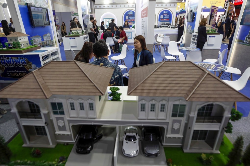 Potential homebuyers evaluate residential promotions from a salesperson at the 47th House and Condo Expo in Bangkok, Thailand, on March 20, 2025. Photo: EPA-EFE
