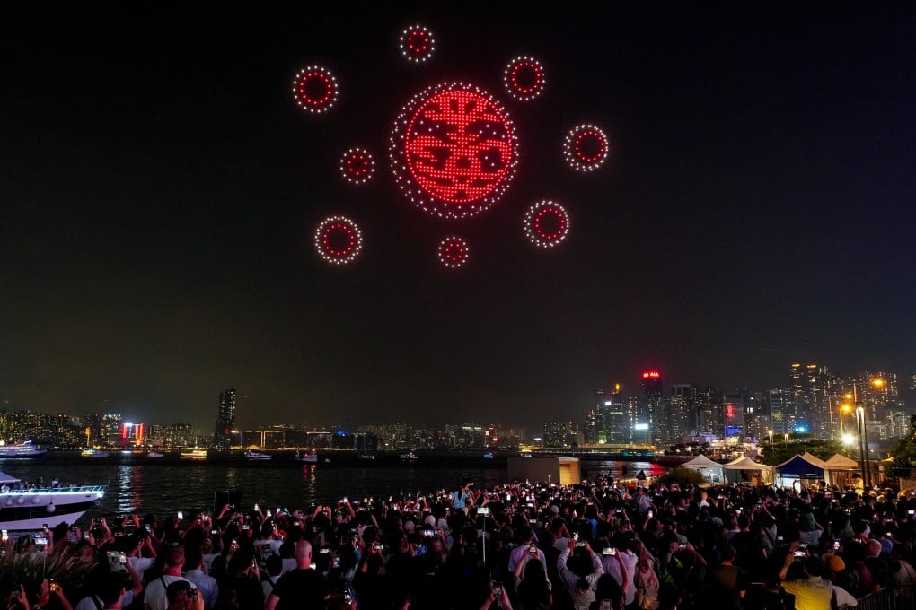People gather at the Wan Chai promenade to watch a drone show on the Labour Day public holiday. Photo: Elson Li