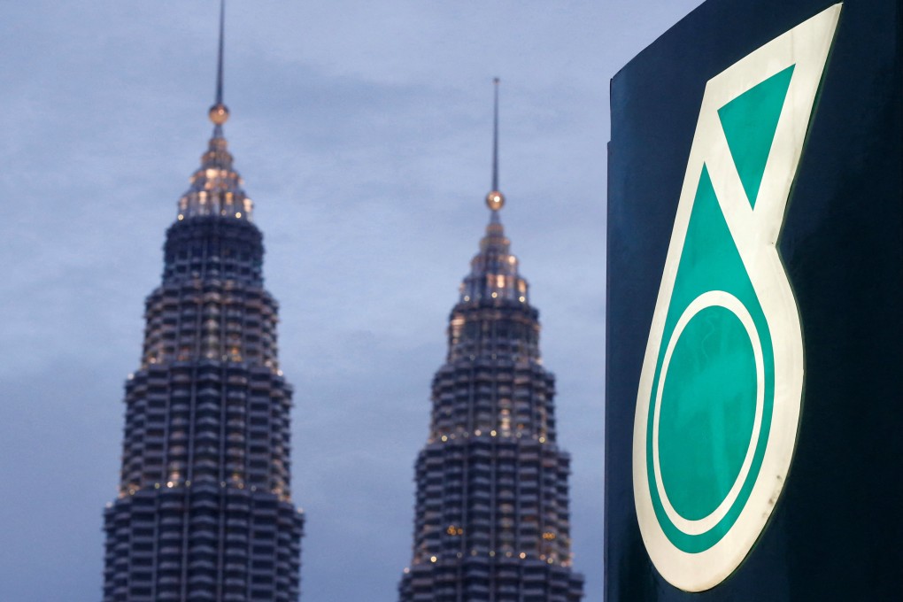 The logo of a Petronas petrol station is seen with the Petronas Twin Towers in the background in Kuala Lumpur. Photo: Reuters