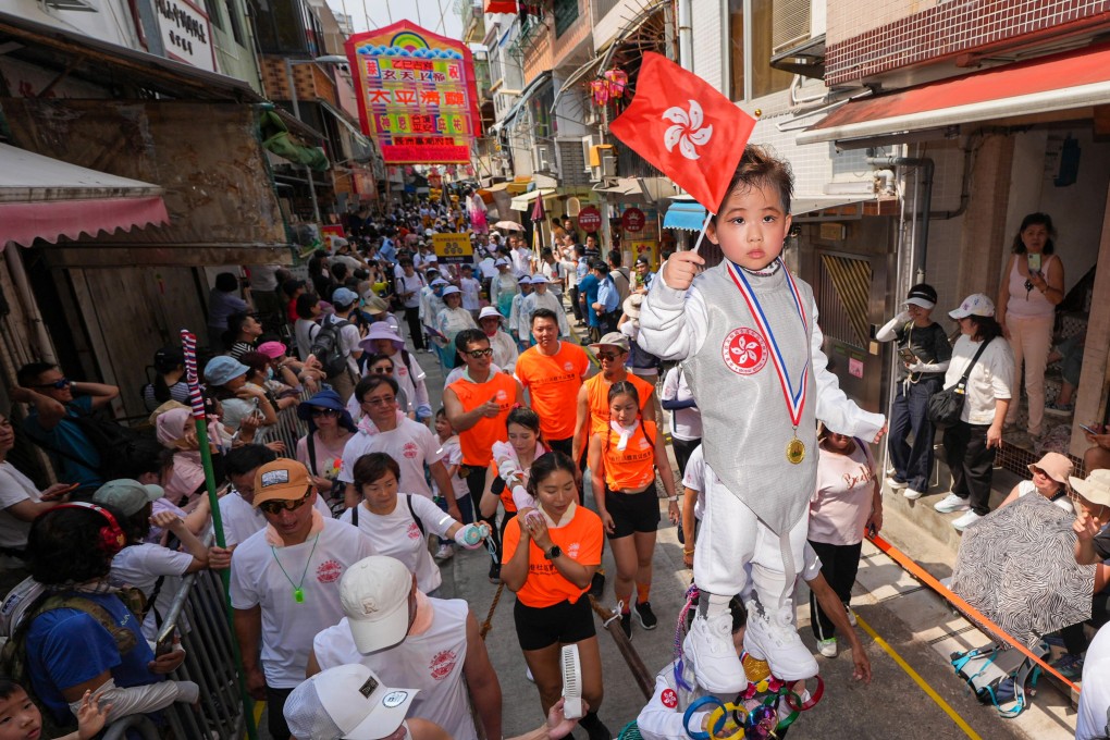 Hongkongers and tourists enjoy the Piu Sik Parade at the Cheung Chau Bun Festival. Photo: Eugene Lee