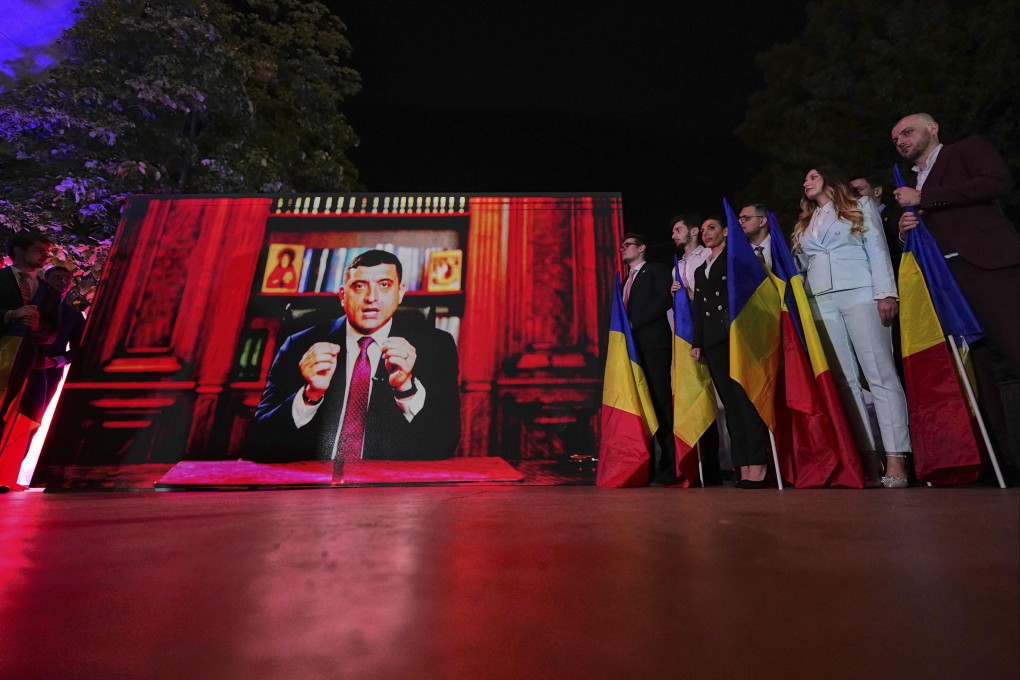 Romanian presidential candidate George Simion addresses supporters via video link after polls closed. Photo: AP
