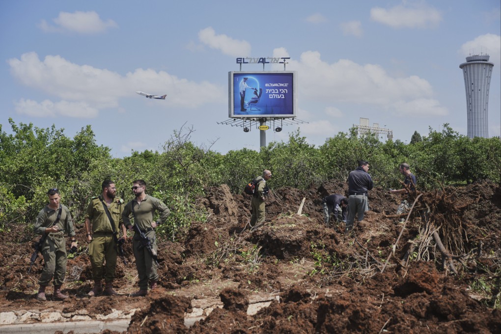 Israeli security forces inspect where a projectile fired by Yemen’s Houthi rebels landed in the area of Ben Gurion International Airport near Tel Aviv. Photo: AP
