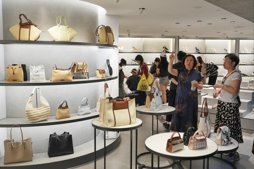 Customers browse handbags at a boutique store in Mong Kok. Photo: Elson Li