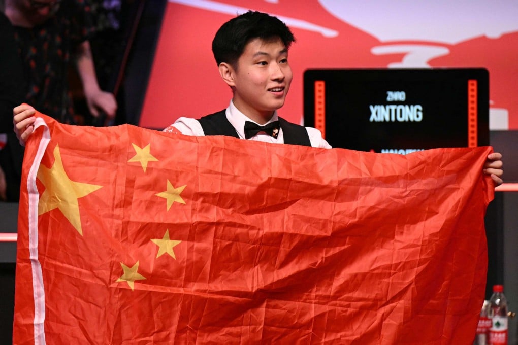 Zhao Xintong poses with China’s flag after winning the World Snooker Championship in Sheffield. Photo: AFP
