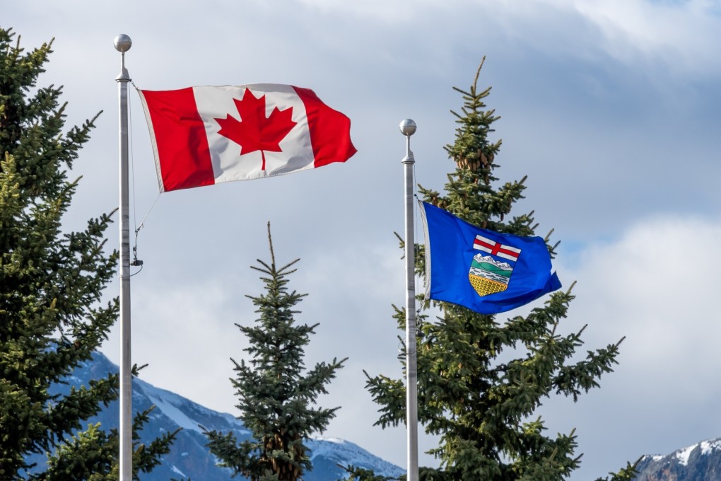 The national flag of Canada and flag of Alberta. Photo: Shutterstock