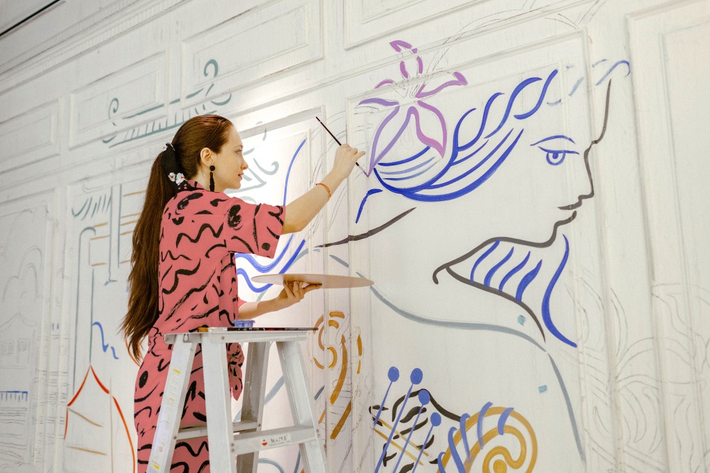 Artist Sanja Kovacevic hand-paints a mural at La Petite Maison in Central, Hong Kong. Photo: Nicholas Wong Sixteen Photography