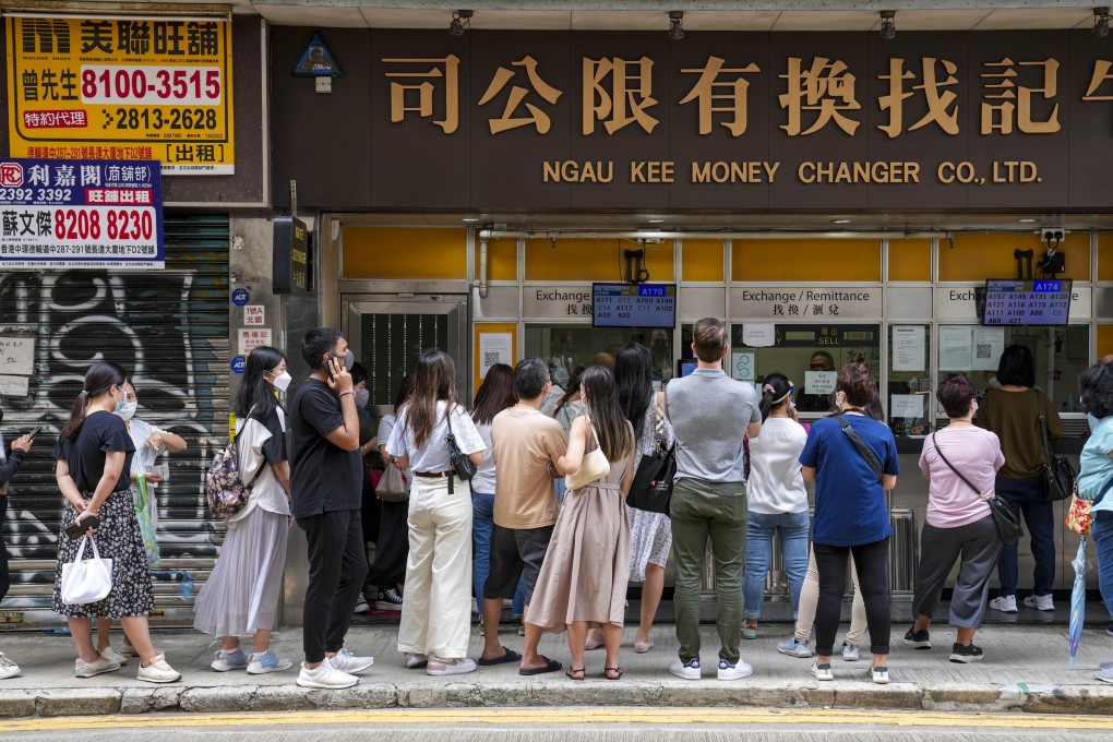 People queue outside a money changer in Sheung Wan. Photo: Sam Tsang