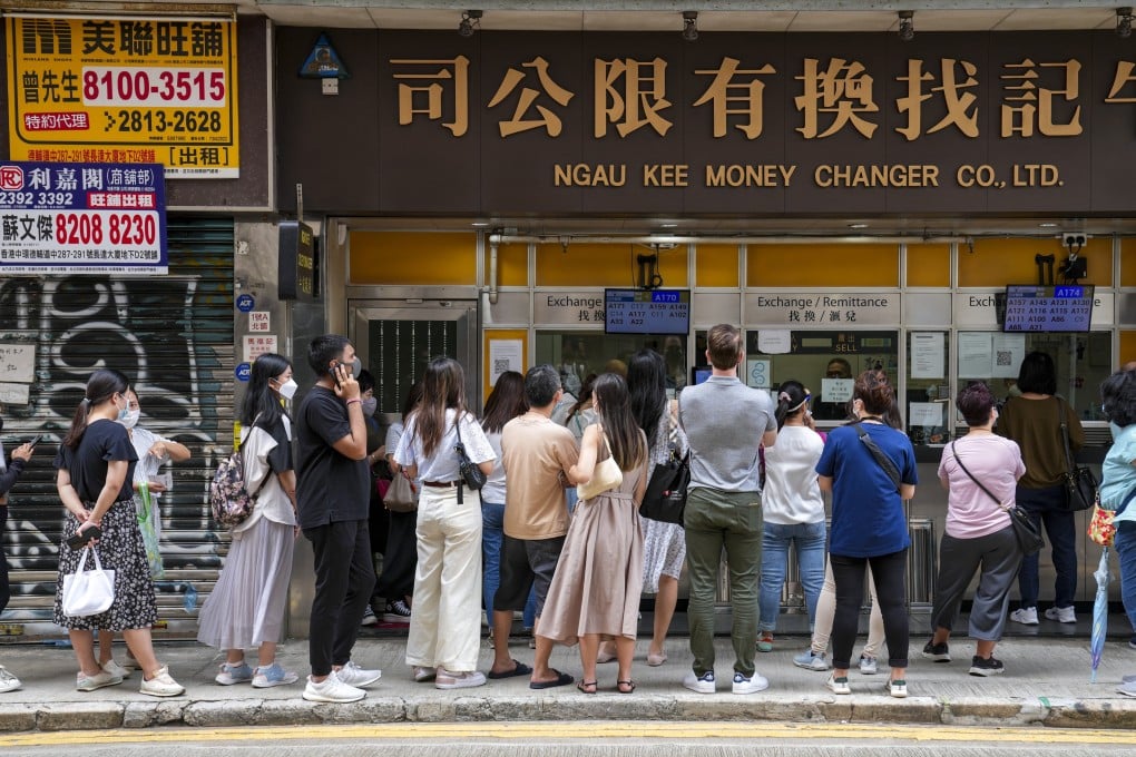 People queue outside a money changer in Sheung Wan. Photo: Sam Tsang