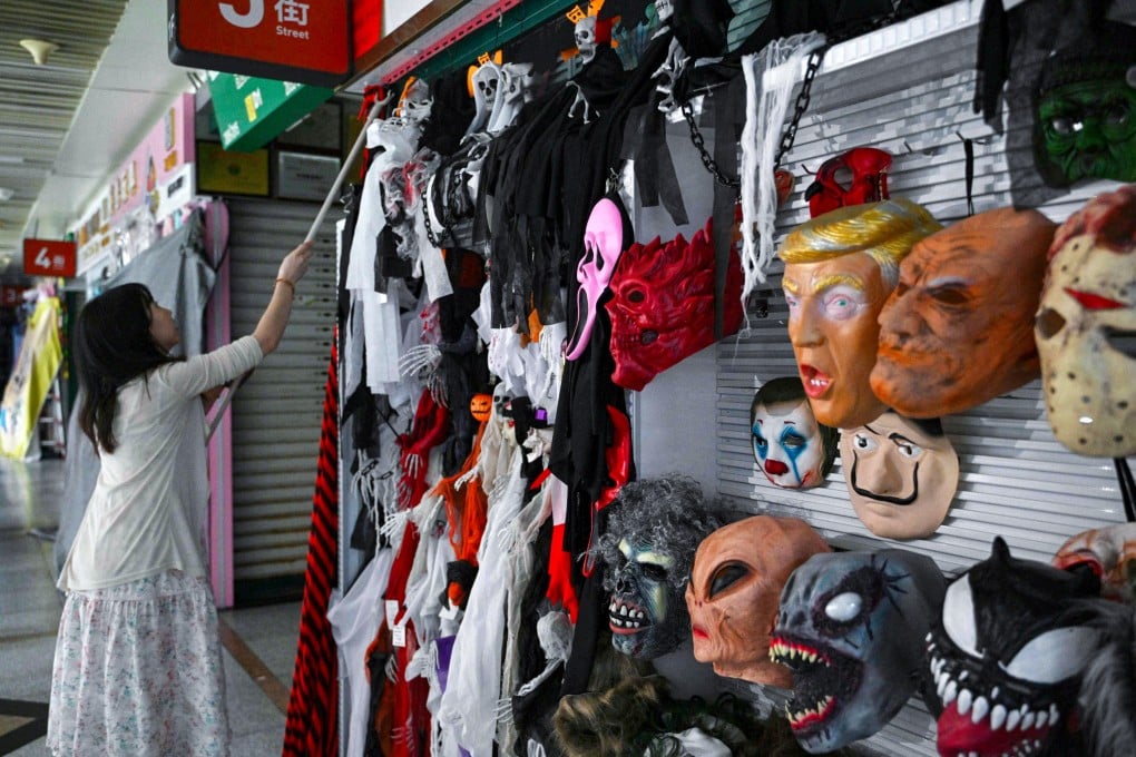 A vendor manages her shop selling Halloween masks at the Yiwu International Trade Market in China’s Zhejiang province on April 11. Photo: AFP