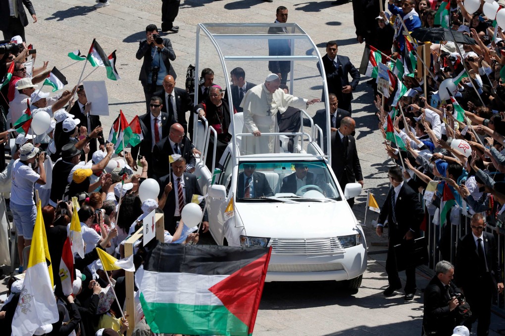 Pope Francis waves to the crowd from his popemobile in Bethlehem, West Bank in 2014. File photo: AFP