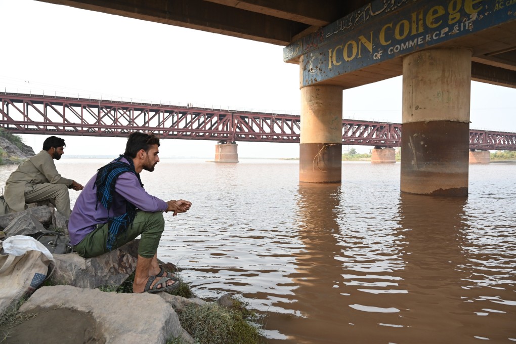 People sit on the bank of the Chenab River flowing through Chiniot, Punjab province, Pakistan, on May 6. India has halted water flow from the Chenab into Pakistan, prompting Islamabad to warn that any reduction in water would be viewed as an “act of war”. The suspension of the Indus Waters Treaty, which has governed water-sharing since 1960, has escalated the conflict between the nuclear-armed neighbours. Photo: EPA-EFE