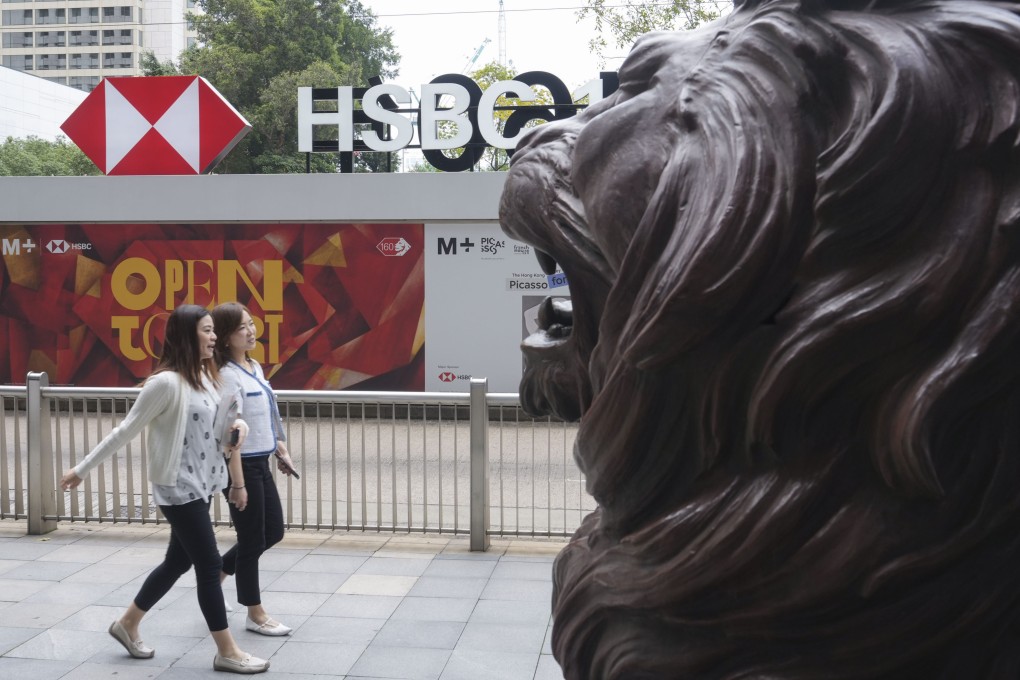 People walking past a lion sculpture outside HSBC’s main office building in Central. Photo: Sun Yeung