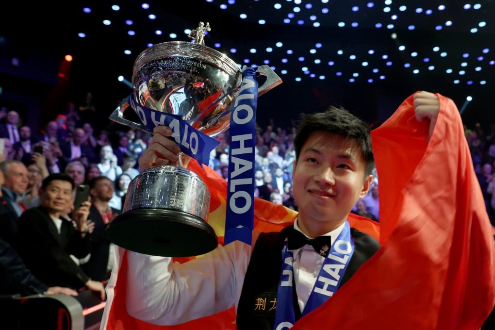 Zhao Xintong celebrates with the trophy after winning the World Snooker Championship on Monday. Photo: Xinhua