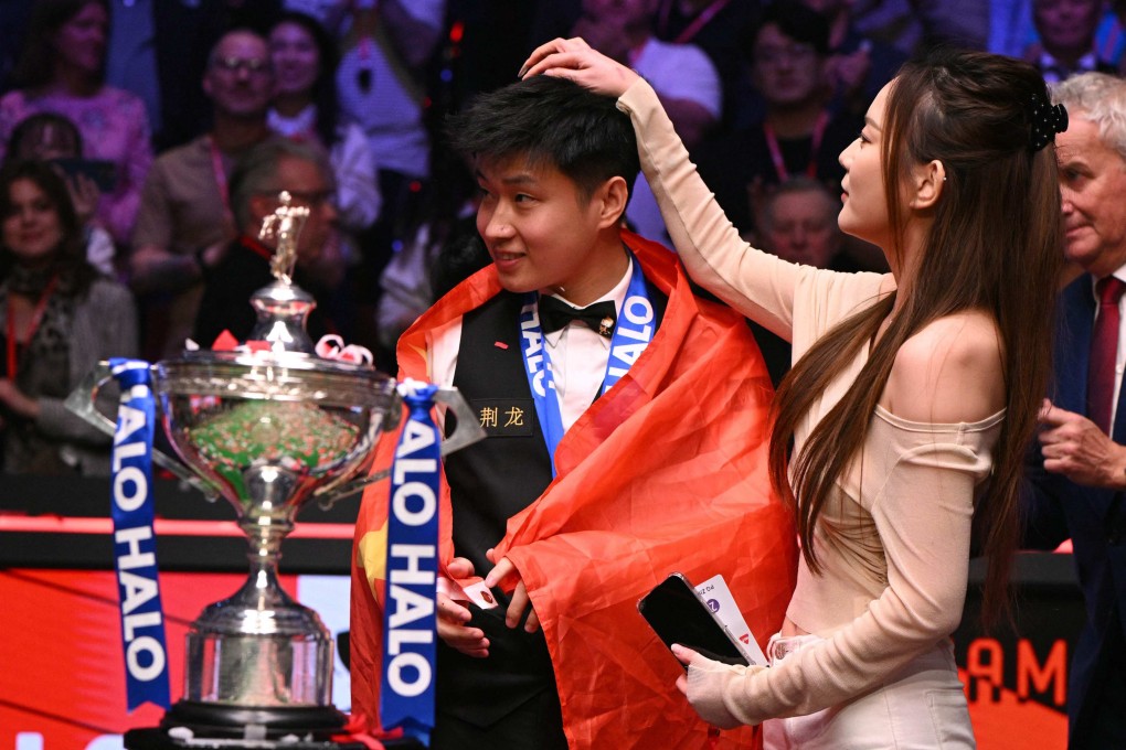 China’s Zhao Xintong has confetti picked from his hair by his girlfriend after victory over Wales’ Mark Williams in the World Championship Snooker final on Monday. Photo: AFP