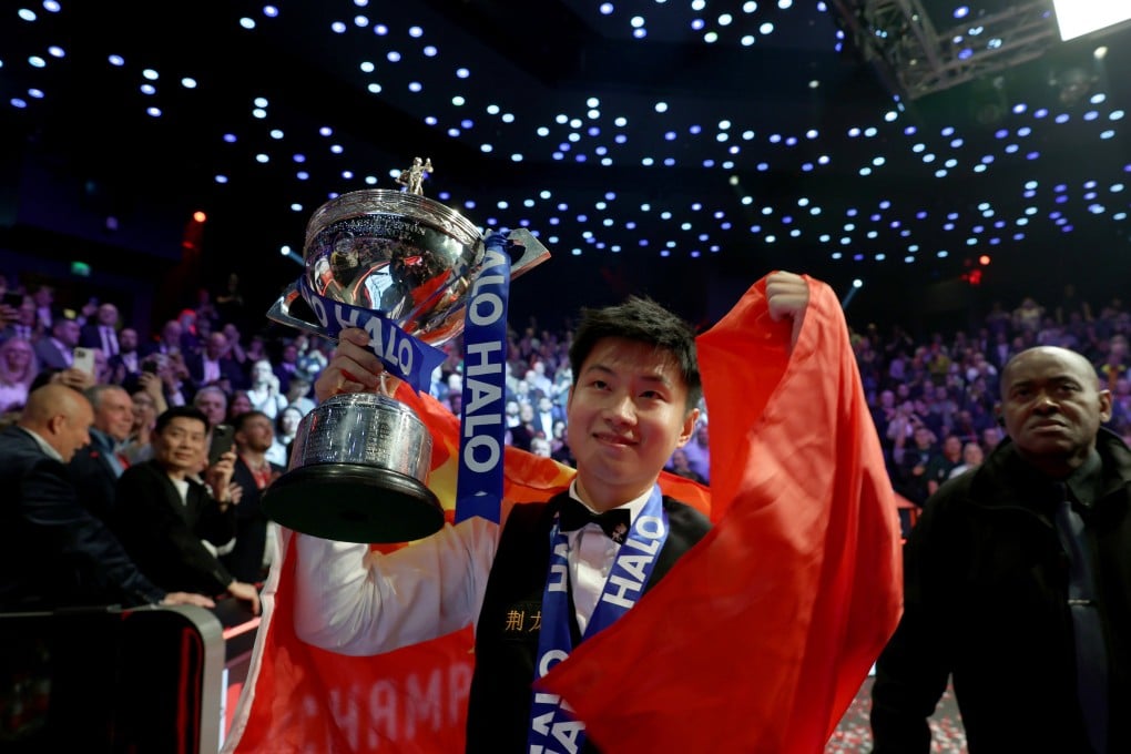 Zhao Xintong celebrates with the trophy after claiming the title by defeating Mark Williams of Wales in the final at World Snooker Championship. Photo: Xinhua
