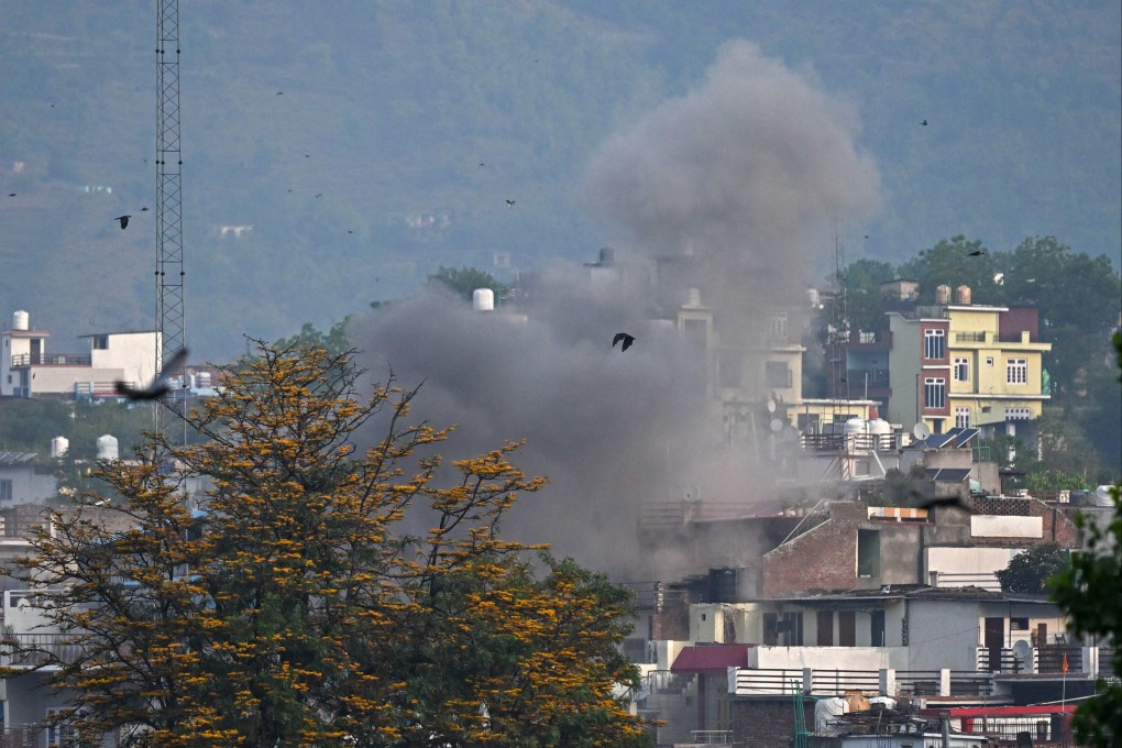 Smoke billows on Wednesday after an artillery shell lands in Poonch district in India’s Jammu region. Photo: AFP