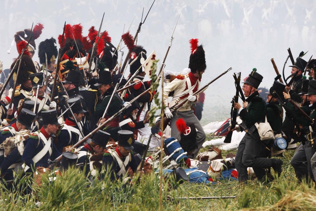 History enthusiasts, dressed as members of the French and British Army, fight during a re-enactment of Napoleon’s famous battle of Waterloo in Braine-l’Alleud on June 21, 2009. History is replete with examples of empires undone by their leaders’ hubris. Photo: Reuters