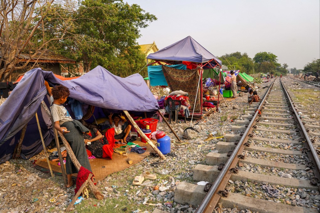People are seen at a shelter in a makeshift tent camp near a railway track, following a strong earthquake in Amarapura township, Myanmar. Photo: Reuters