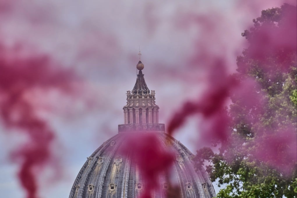 Pink smoke rises in front of St Peter’s Dome during a protest by the Women’s Ordination Conference in Rome on Wednesday. Photo: AP