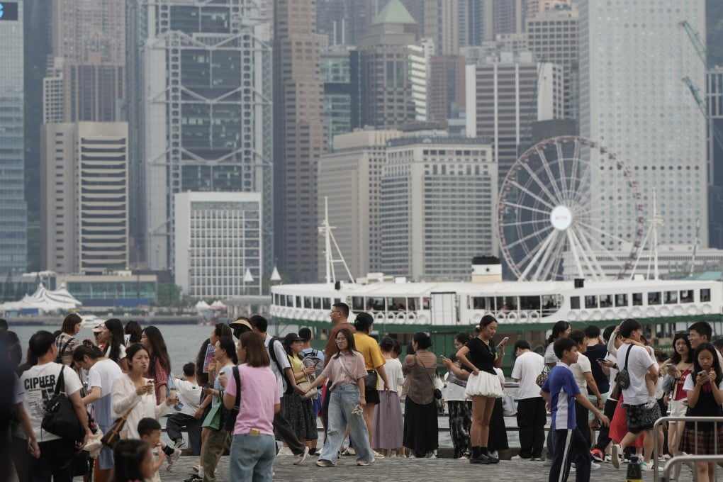 Tourists visit at the waterfront of Victoria Harbour in Tsim Sha Tsui, during the “Golden Week”. 04MAY25 SCMP/ Sam Tsang