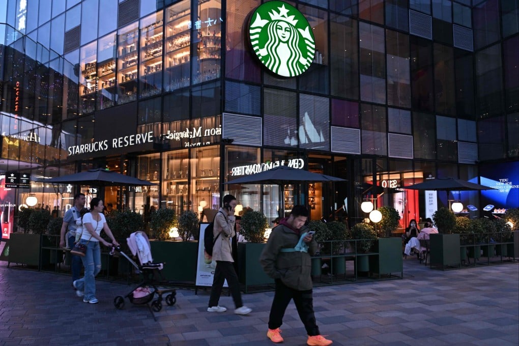 People pass a Starbucks cafe in Beijing on April 9, 2025. Photo: AFP