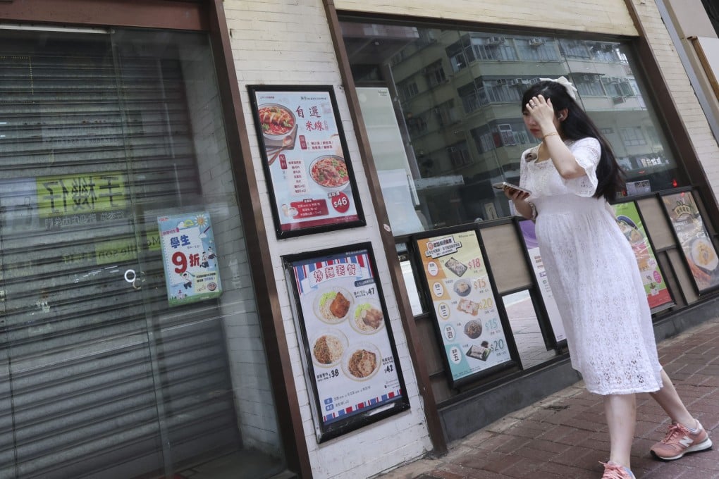 A pedestrian passes a shuttered Ocean Empire congee shop on Johnston Road in Wan Chai on May 8. The restaurant chain, in operation since 1992, suddenly announced the closure of all its locations on May 7. Photo: Jelly Tse