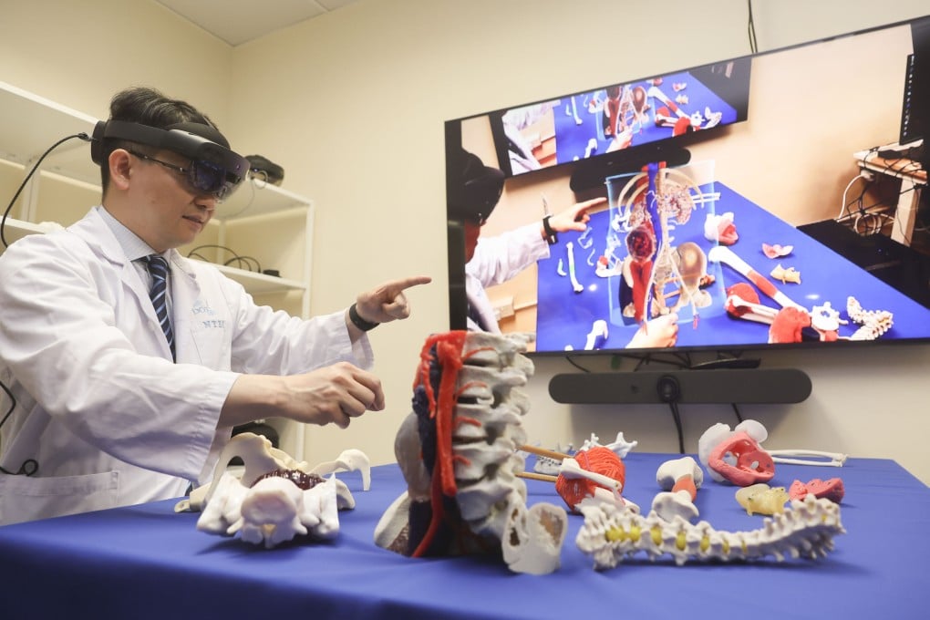 Dr Wong Kwok-chuen uses a mixed reality surgical guidance system during a press conference. Photo: Edmond So