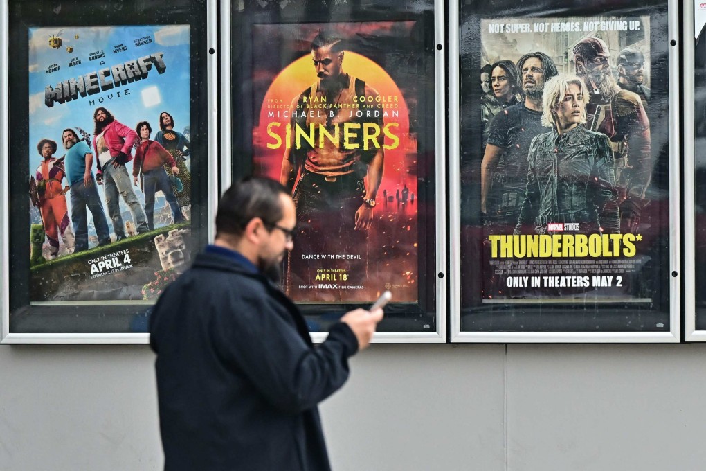 A man walks past movie posters at at AMC Theater in Montebello, California on May 5. US President Donald Trump said he was ordering new tariffs on all films made outside the United States, claiming Hollywood was being “devastated” by a trend of US filmmakers and studios working abroad. Photo: AFP