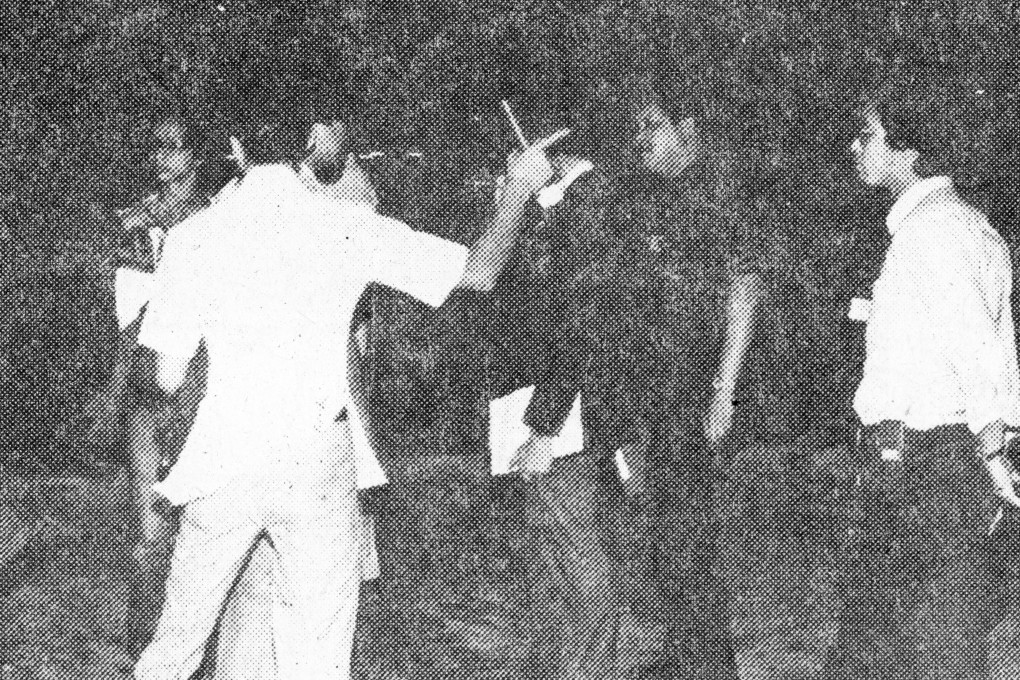 Police investigate at a crime scene at Wah Fu Estate, Aberdeen, in May 1980 where a young man was stabbed to death and his friend seriously injured. Photo: SCMP Archives