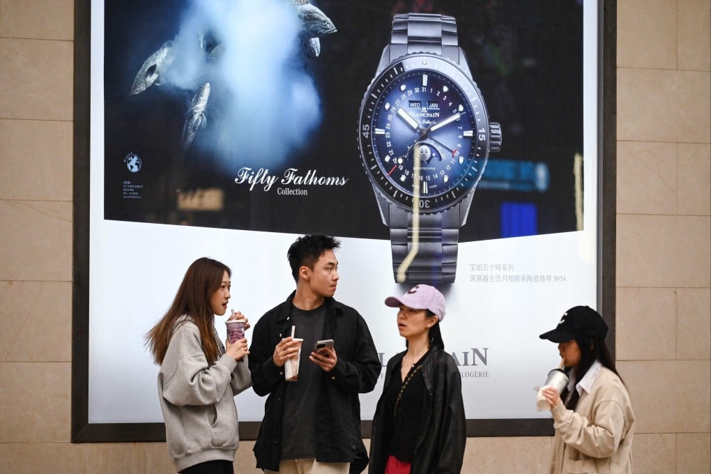 People talk near a Blancpain luxury watch store in Beijing on May 5, 2025. Photo: AFP