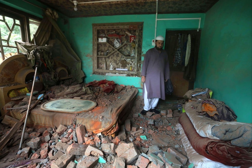 A Kashmiri villager inspects a house damaged after cross-border shelling from Pakistan, at Gingal village in Uri, Indian-administered Kashmir, on Friday. Photo: EPA-EFE