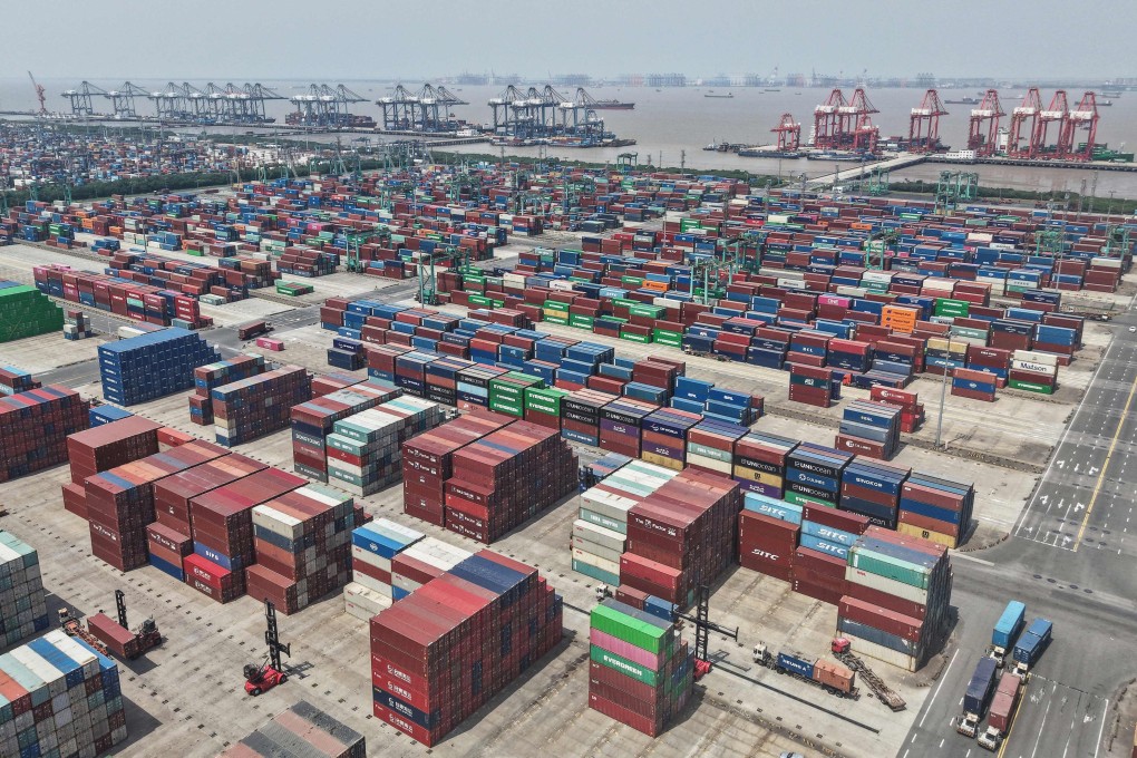 Shipping containers are stacked at a port in Shanghai on Friday. Photo: AFP