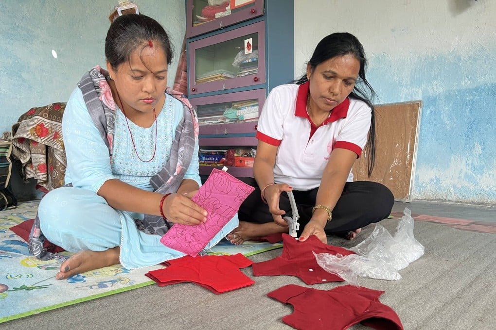 Anjana Kumal (left) and Maya Devi Sunar putting final touches on reusable cloth pad at the Miteri Jaibik Pad Udhyog factory in Chitwan. Photo: Bibek Bhandari