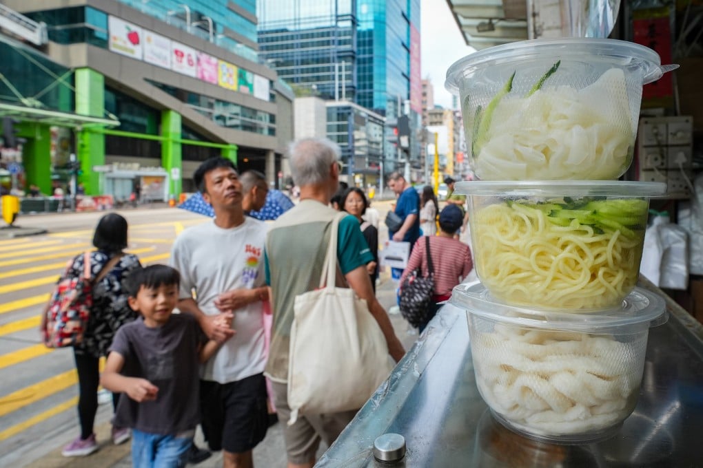 Pedestrians walk by a shop in Sham Shui Po using single-use plastics, on October 20, 2024. Photo: Eugene Lee