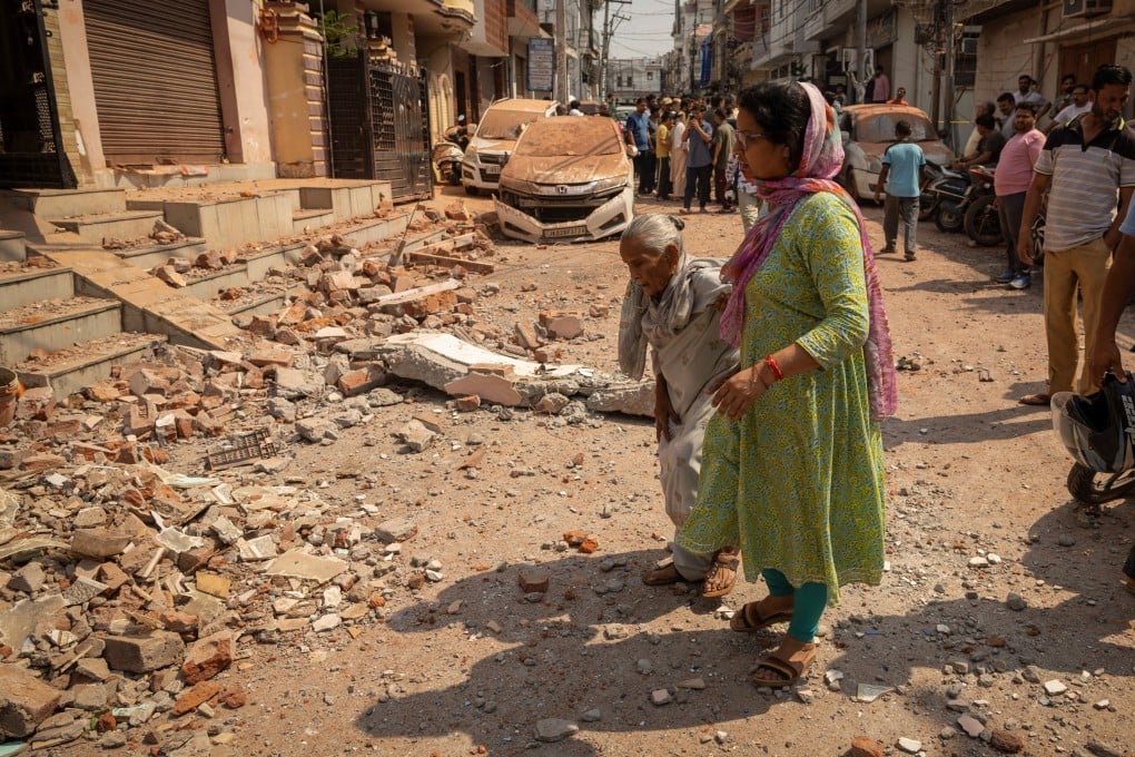 Women walk towards their damaged home following Pakistan’s military operation against India, in Rehari, Jammu, on Saturday. Photo: Reuters