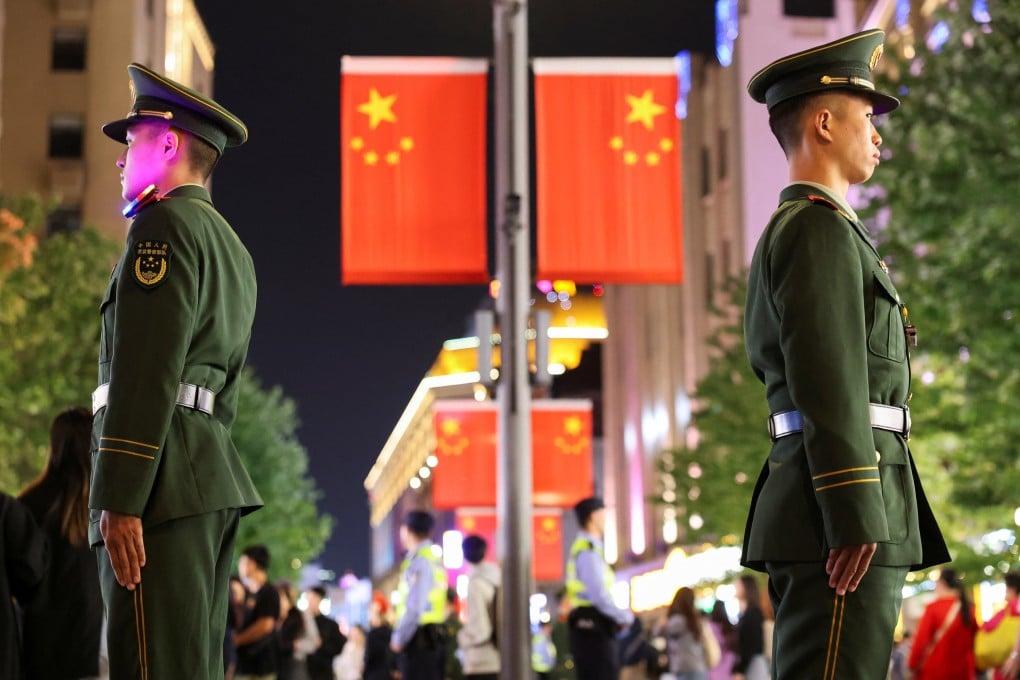 Police officers stand guard on Shanghai’s Nanjing Road on Monday. A top security official has ordered China’s law enforcement agencies to swear “absolute loyalty” to the Communist Party. Photo: Reuters