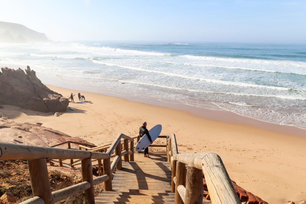 A surfer looks out over Praia do Amado, a beach and surf spot near Sagres and Lagos in Portugal’s southern Algarve region. Photo: Shutterstock