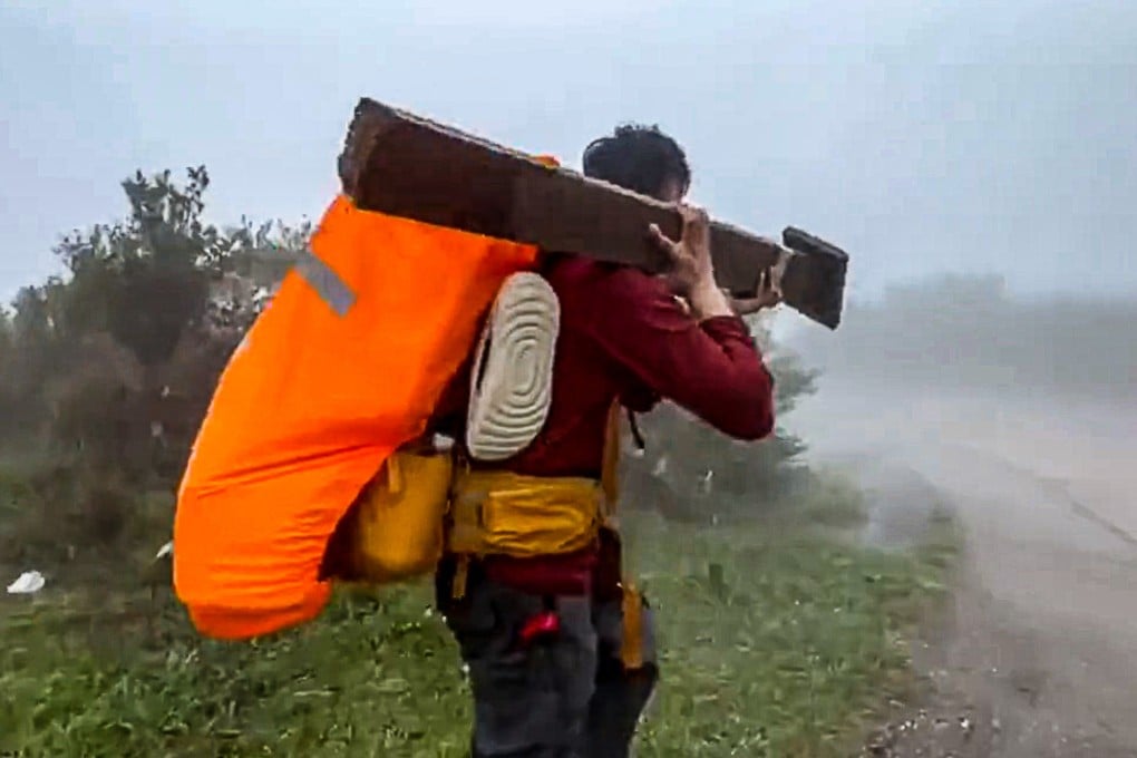 A screengrab of the video shows the man carrying off the trail marker. Photo: Handout