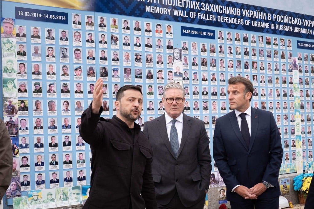 Britain’s Prime Minister Keir Starmer (centre), France’s President Emmanuel Macron (right) and Ukraine’s President Volodymyr Zelensky (left) speak after laying bouquets of flowers as they visit the Wall of Heroes of the Nation, a memorial wall of fallen Ukrainian servicemen, in Kyiv on Saturday. Photo: AFP